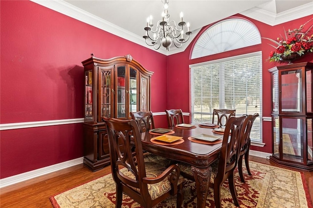 dining area featuring a chandelier, hardwood / wood-style floors, and crown molding