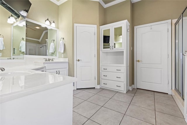 bathroom featuring tile patterned floors, crown molding, and a shower with shower door