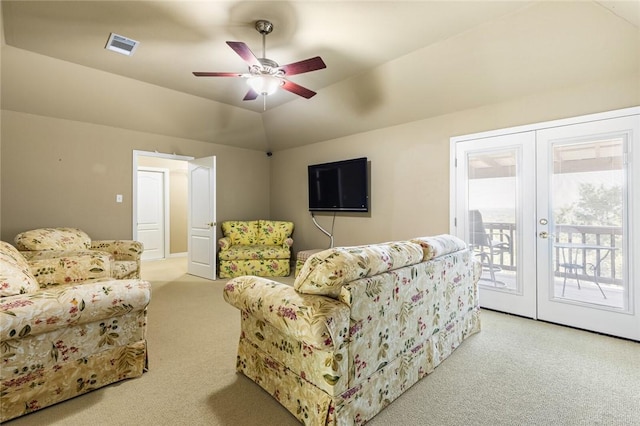 living room featuring light colored carpet, ceiling fan, and lofted ceiling