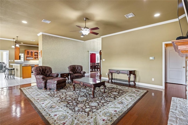 living room featuring ceiling fan, light hardwood / wood-style flooring, and crown molding