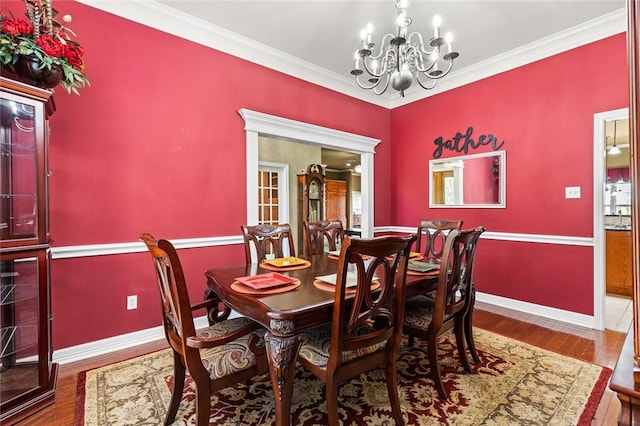 dining room with ornamental molding, a chandelier, and hardwood / wood-style flooring