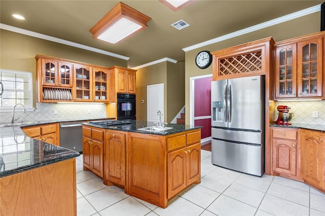 kitchen featuring light tile patterned flooring, crown molding, sink, a kitchen island, and stainless steel appliances