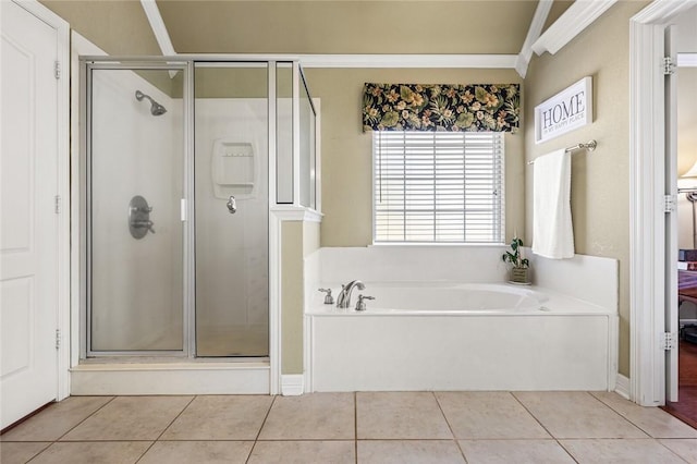 bathroom with tile patterned flooring, independent shower and bath, and ornamental molding