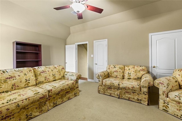 carpeted living room with ceiling fan and lofted ceiling