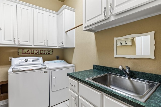 clothes washing area with light tile patterned flooring, cabinets, independent washer and dryer, and sink