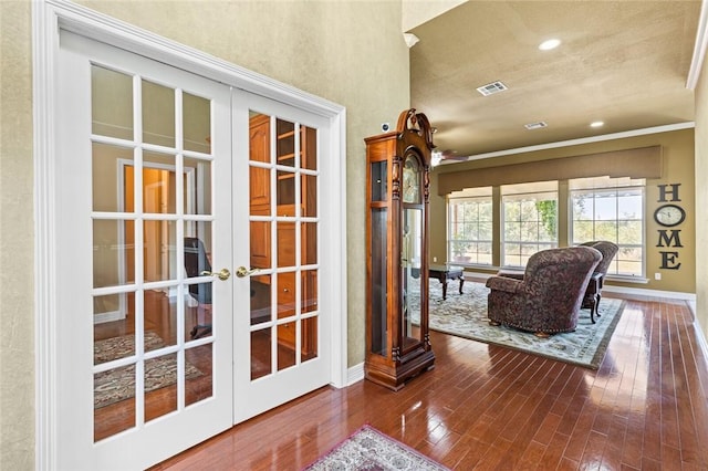 doorway with hardwood / wood-style floors, a textured ceiling, and french doors