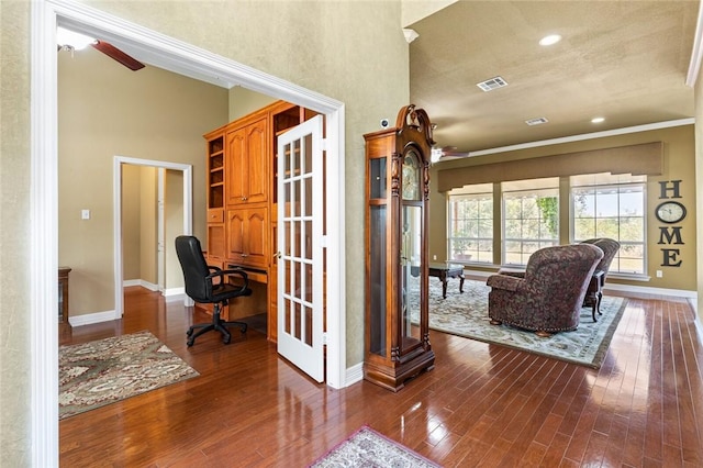 interior space featuring hardwood / wood-style floors, high vaulted ceiling, ceiling fan, and ornamental molding