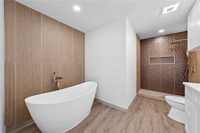 full bathroom featuring vanity, plus walk in shower, wood-type flooring, and toilet