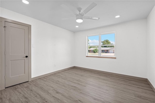 empty room with ceiling fan and wood-type flooring