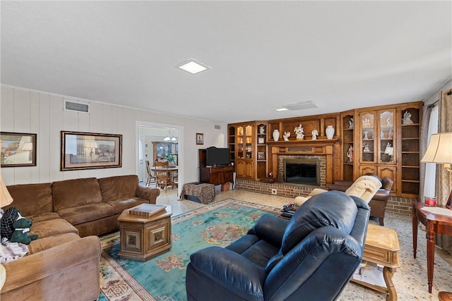 living room with a brick fireplace