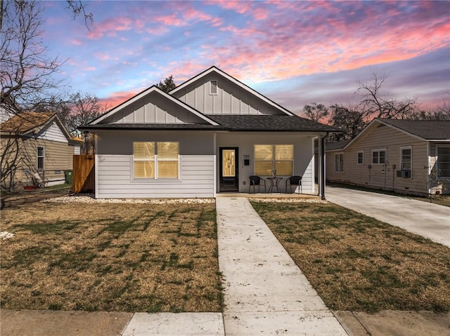 bungalow-style home featuring board and batten siding, a front yard, and covered porch