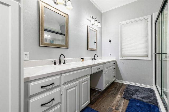 bathroom with vanity, crown molding, wood-type flooring, and walk in shower