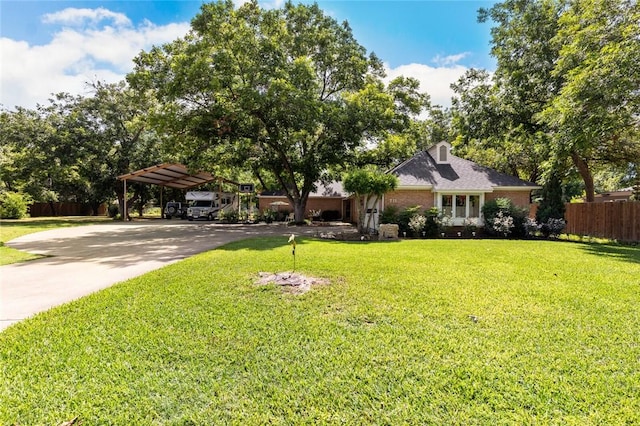 view of front of property featuring a front lawn and a carport