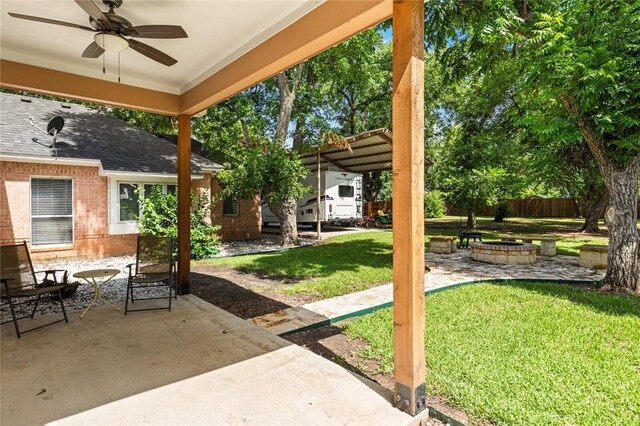 view of patio / terrace with ceiling fan and an outdoor fire pit