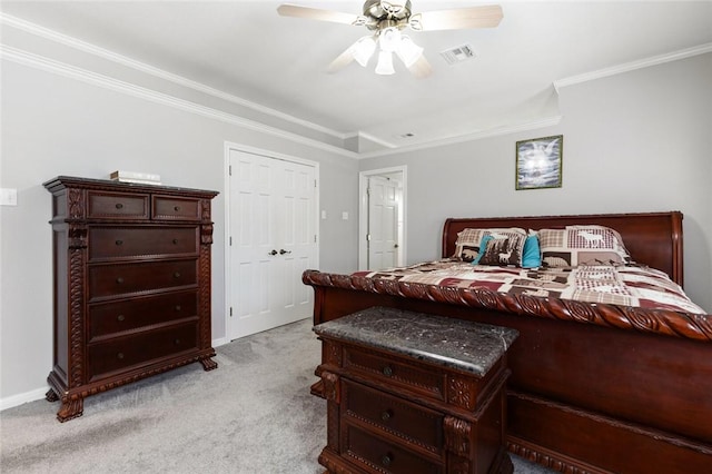 bedroom with crown molding, ceiling fan, a closet, and light carpet