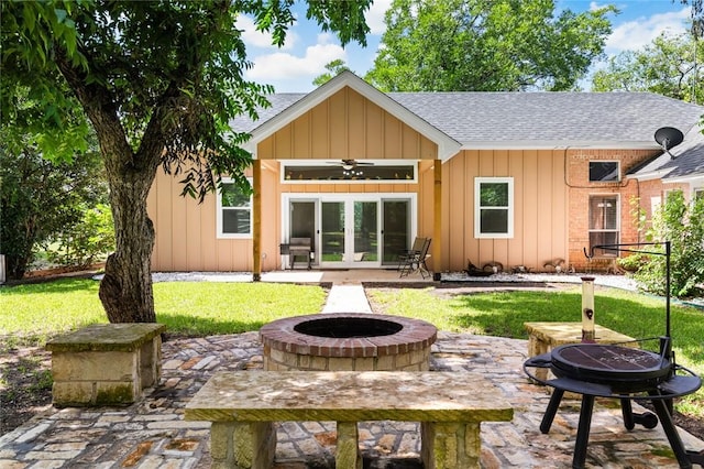 rear view of house featuring a fire pit, a patio area, french doors, and ceiling fan