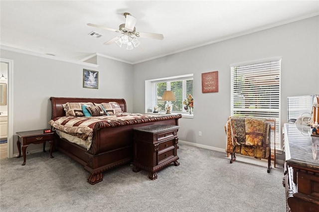 carpeted bedroom featuring crown molding, ensuite bath, and ceiling fan