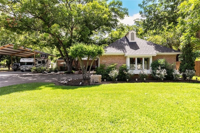 view of front facade featuring a front lawn and a carport