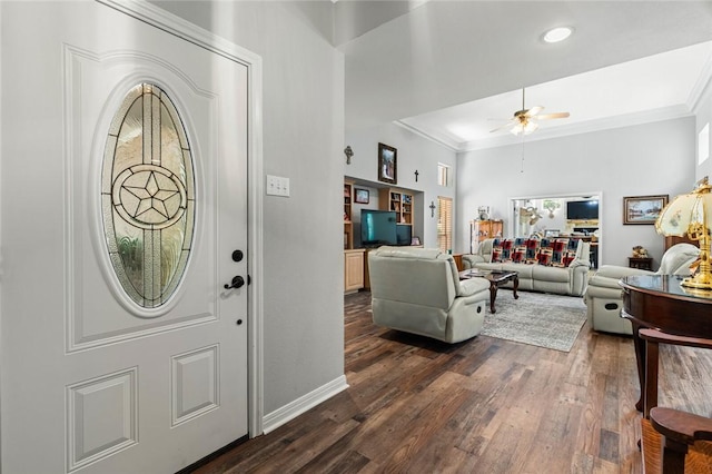 entrance foyer featuring ornamental molding, dark hardwood / wood-style floors, and ceiling fan