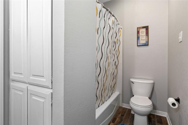 bathroom featuring hardwood / wood-style floors, shower / bath combination with curtain, and toilet