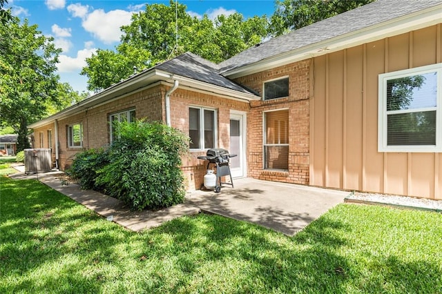 exterior space with a lawn and a patio