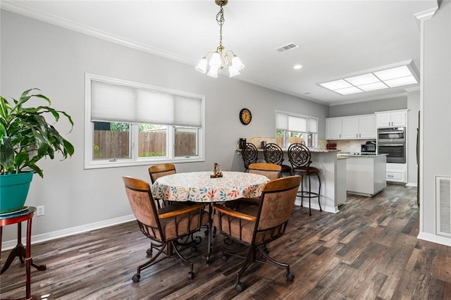 dining room with a wealth of natural light, ornamental molding, and dark hardwood / wood-style floors