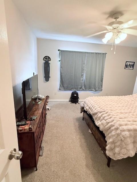 bedroom with light carpet and ceiling fan