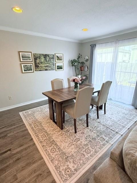 dining room with crown molding and hardwood / wood-style floors