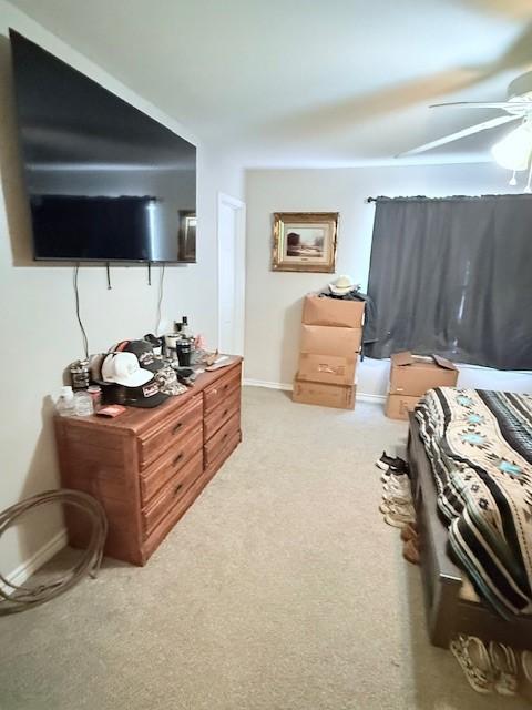 bedroom featuring ceiling fan and light carpet