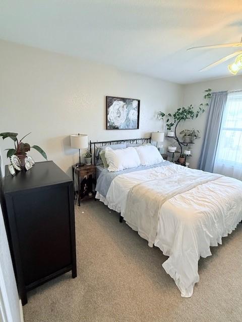 carpeted bedroom with ceiling fan