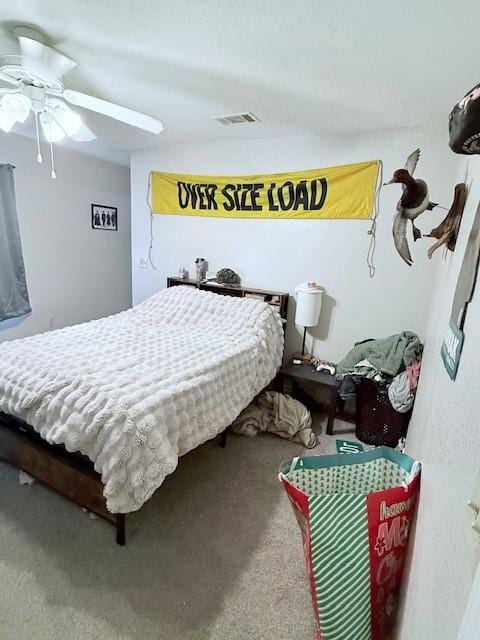 bedroom featuring ceiling fan and carpet