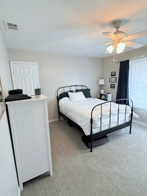 bedroom with ceiling fan and light colored carpet