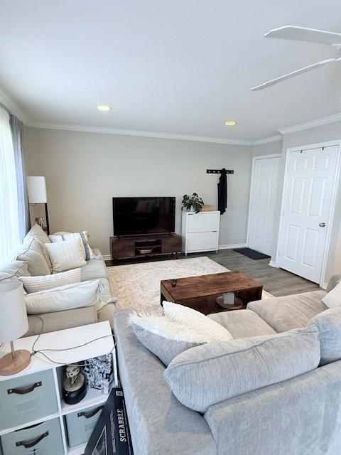 living room featuring ornamental molding and hardwood / wood-style floors