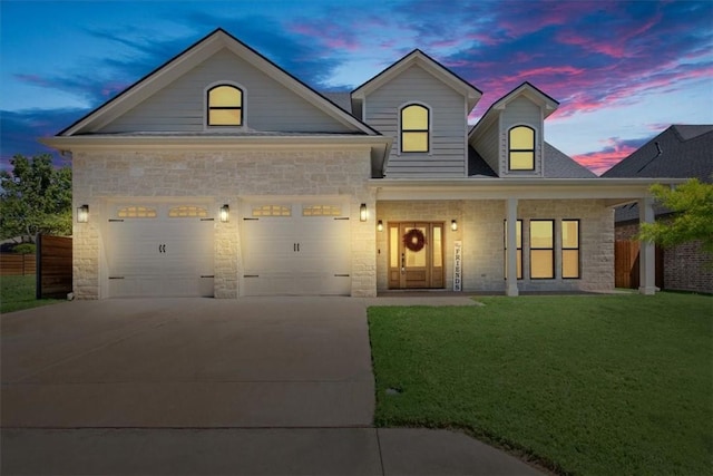 view of front of house featuring a lawn and a garage