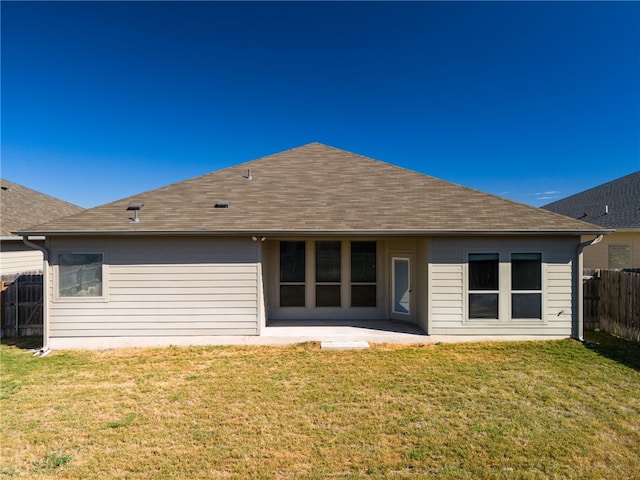 rear view of house with a patio area and a lawn