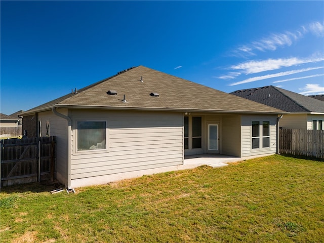 rear view of house featuring a yard and a patio area