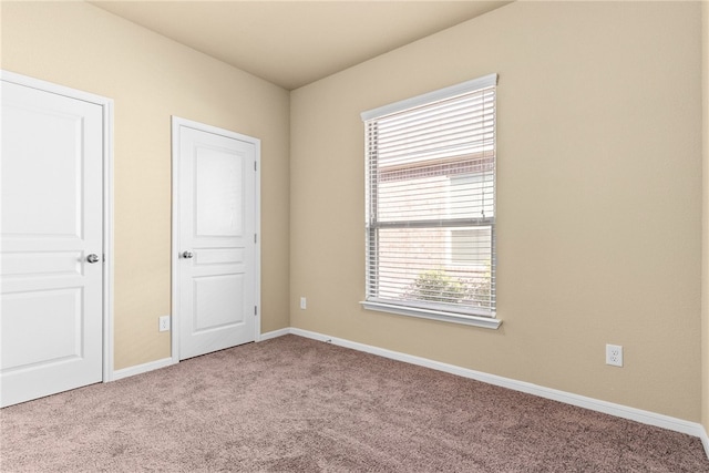 unfurnished bedroom featuring light colored carpet