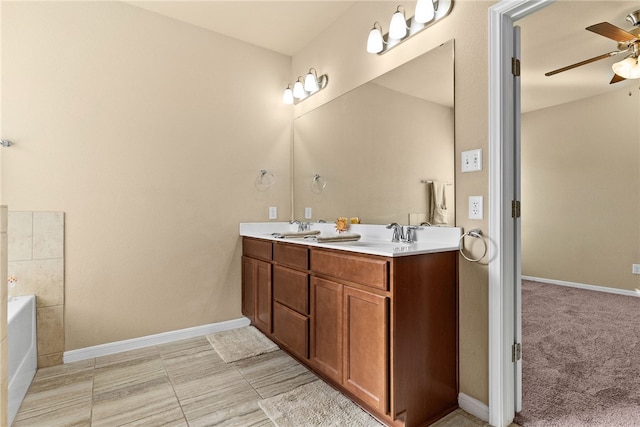 bathroom with vanity, ceiling fan, and a tub to relax in