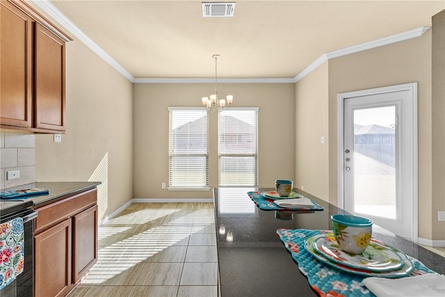 kitchen with hanging light fixtures, ornamental molding, range with electric cooktop, and a chandelier