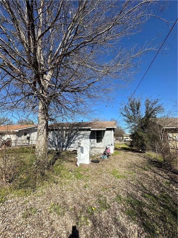 rear view of property with an outdoor structure