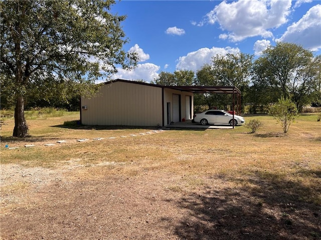 view of home's exterior with a lawn and a carport