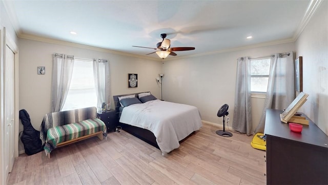 bedroom with ceiling fan, crown molding, and light hardwood / wood-style flooring