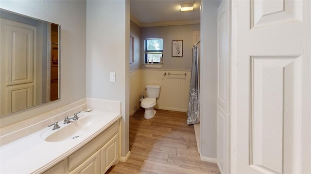 bathroom featuring crown molding, toilet, vanity, and hardwood / wood-style flooring