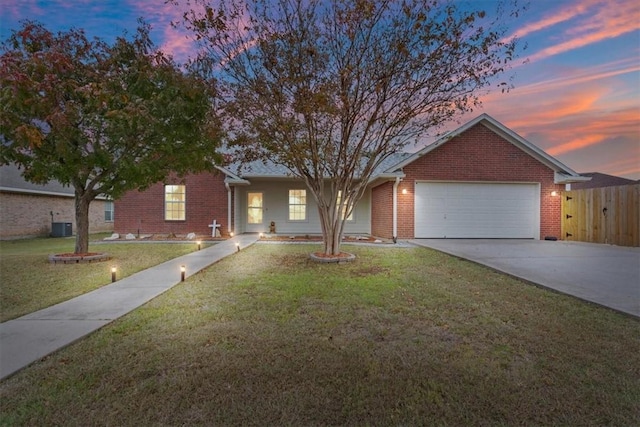 single story home with central AC, a garage, and a lawn