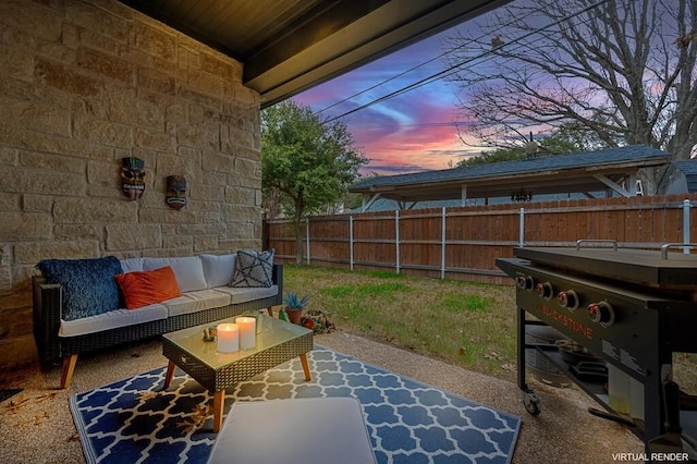 patio terrace at dusk with grilling area and an outdoor hangout area