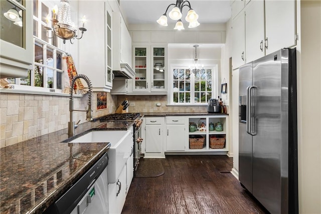 kitchen with white cabinetry, a chandelier, hanging light fixtures, and stainless steel appliances