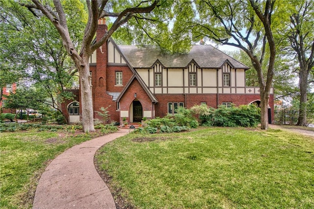 tudor home with a front lawn