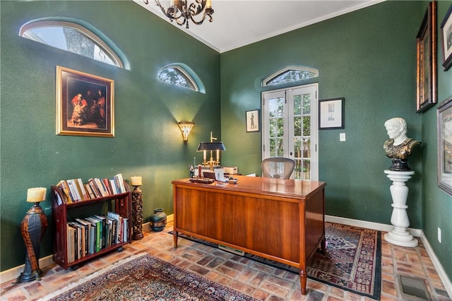 home office with french doors, crown molding, and a chandelier