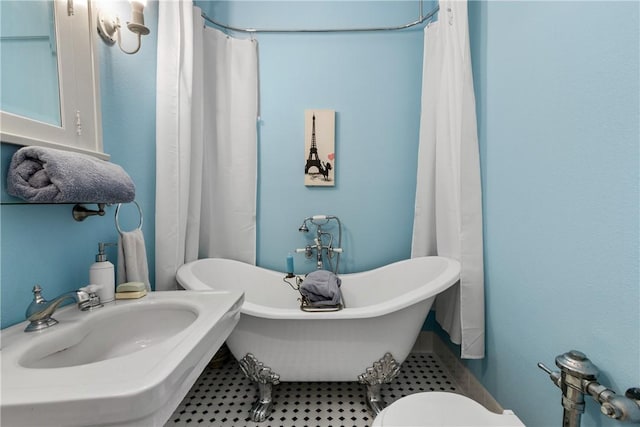 bathroom with a washtub and sink