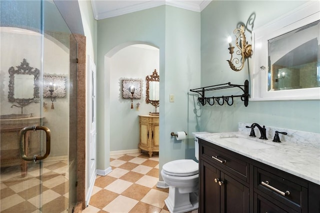 bathroom featuring toilet, vanity, a shower with shower door, and ornamental molding